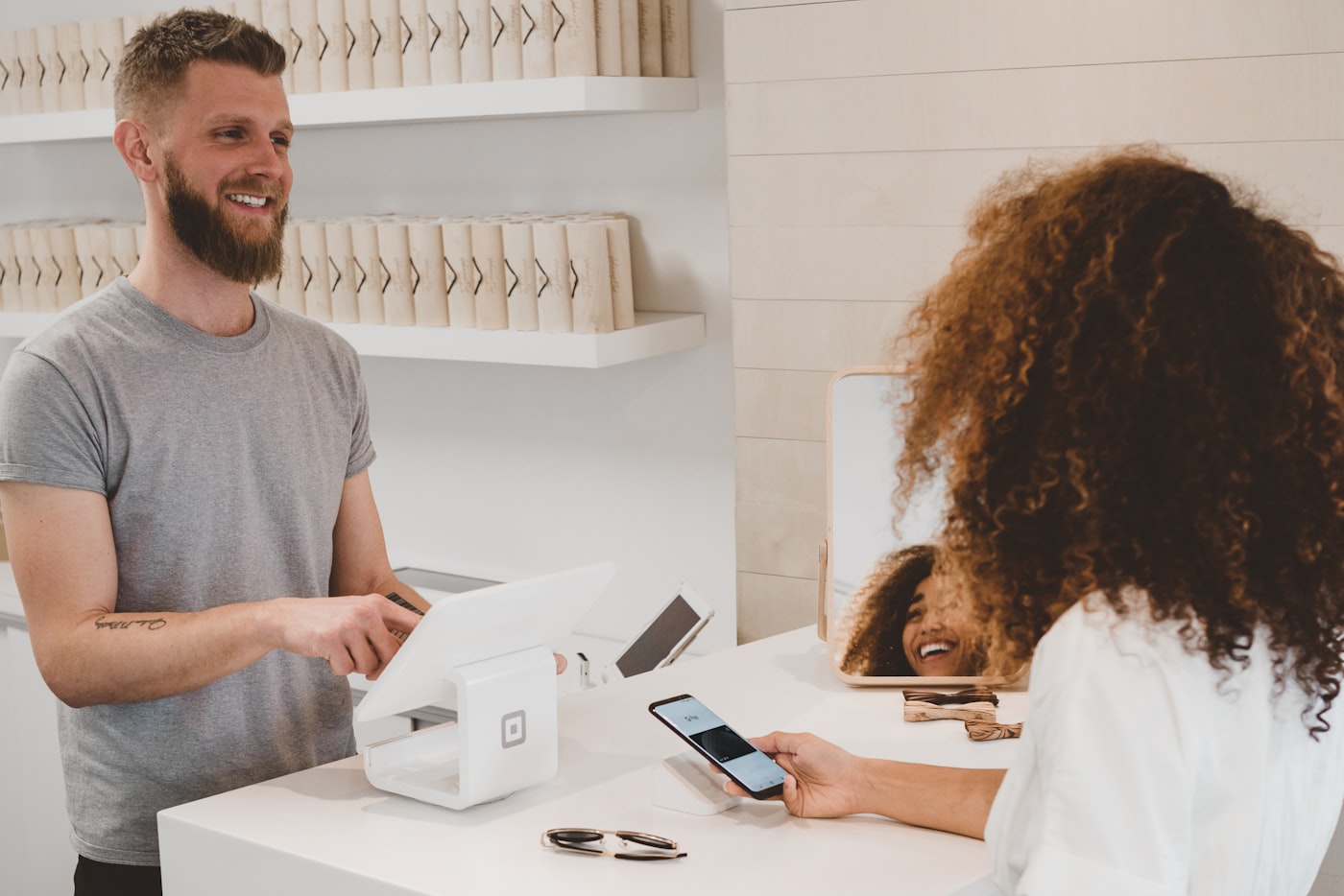 Shopper paying by phone at a checkout terminal